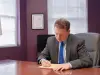 Tate Meagher writing at his desk